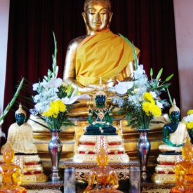 Golden Buddha with flowers