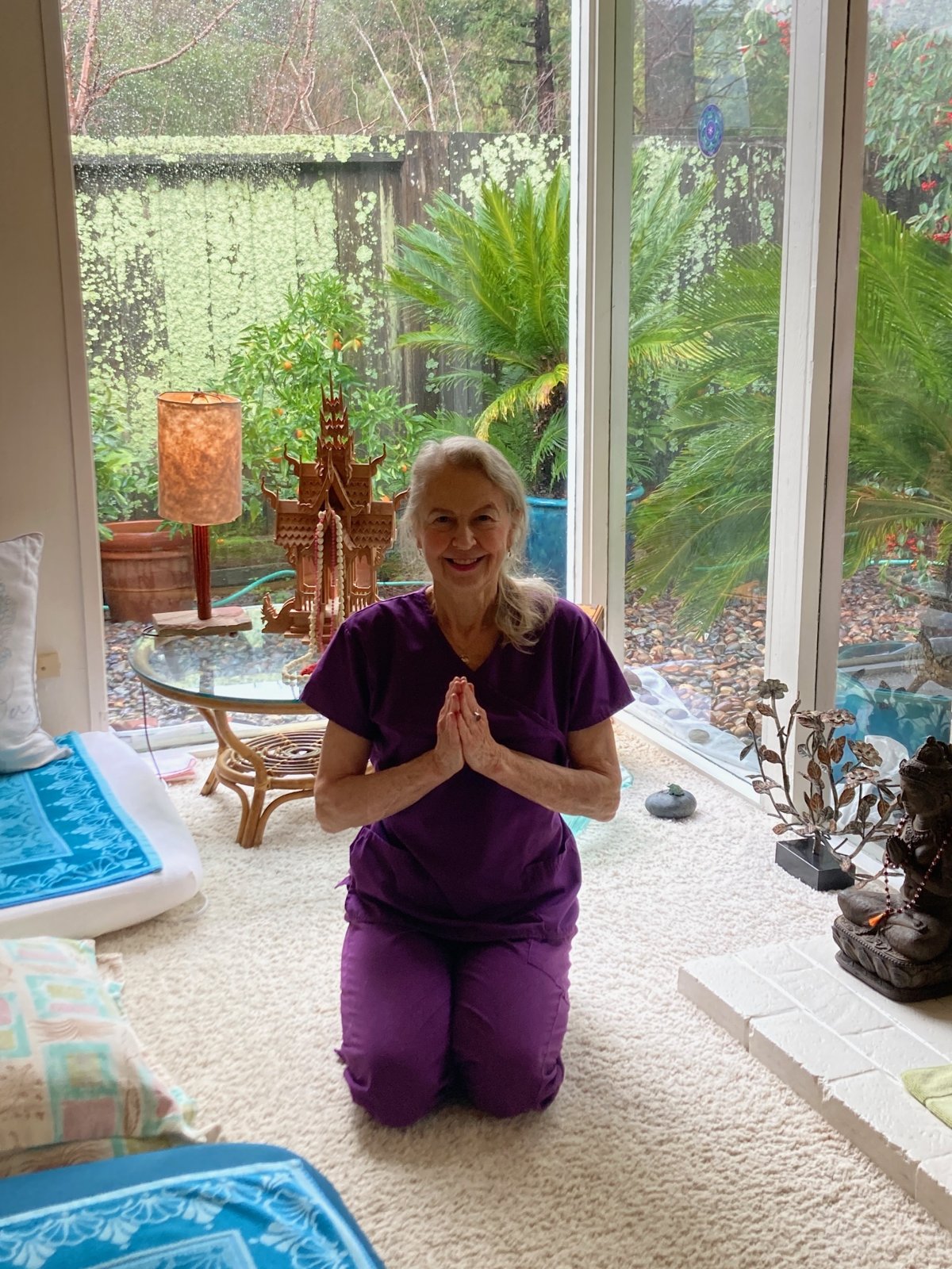 Kimberly Call in a prayer greeting in her Lucas Valley studio