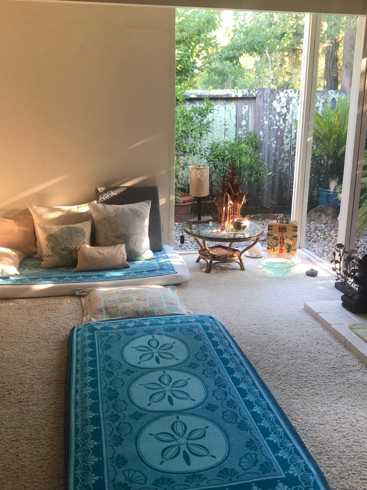 Thai massage mat looking toward the couch and corner window