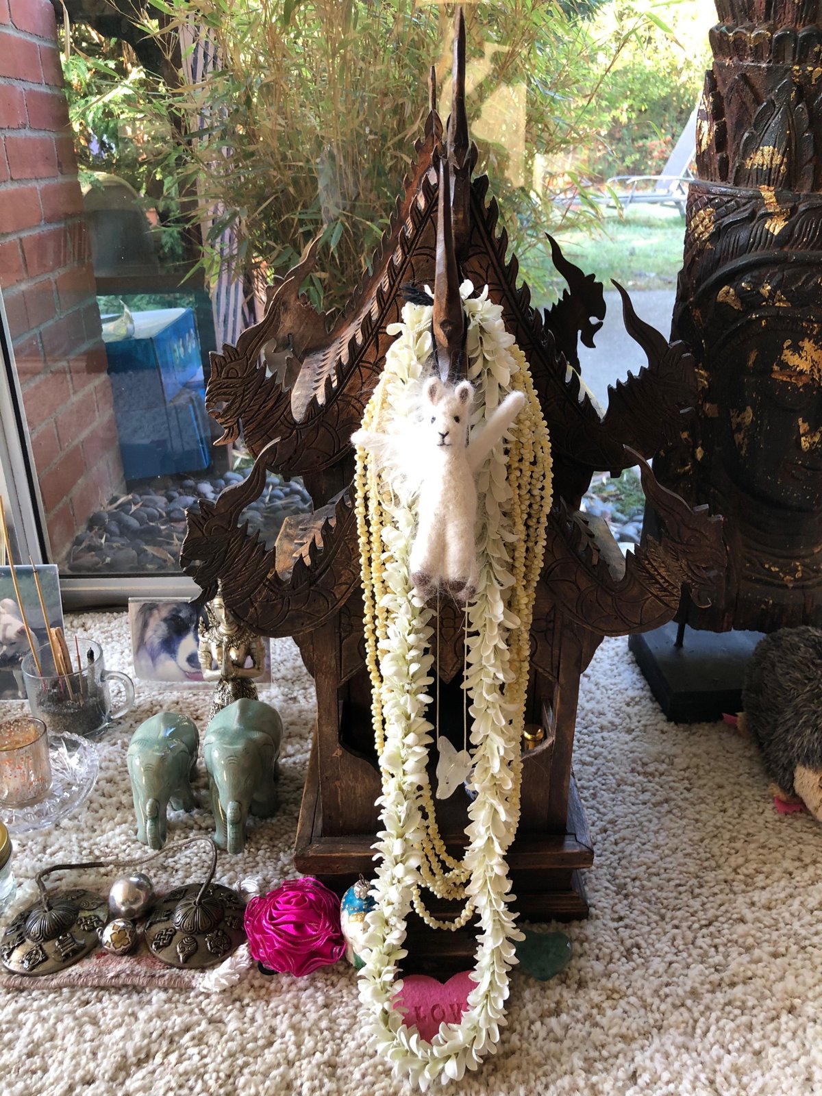 Thai temple shrine with jasmine garlands and flowers